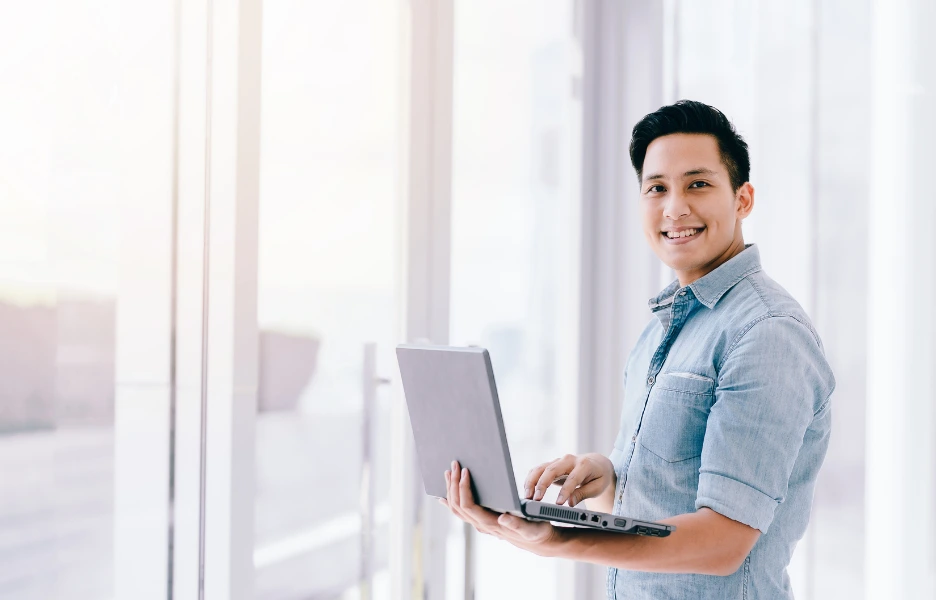 holding laptop